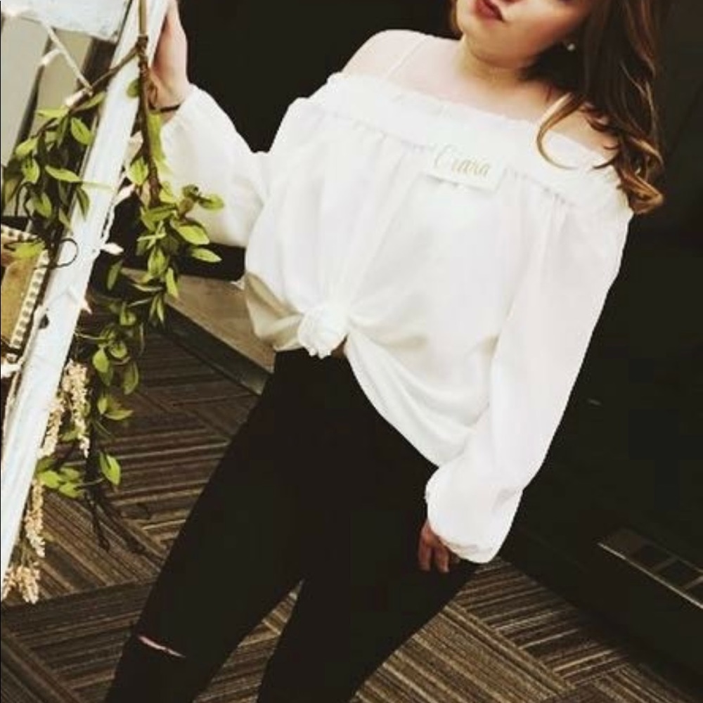 white, long sleeve off the shoulder blouse